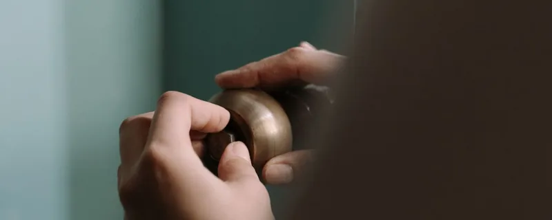 Hands carrying out an under-sink plumbing repair